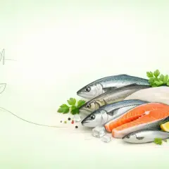 Różnorodne, świeże ryby, w tym łosoś, symbolizują najzdrowsze ryby dla serca i diety.