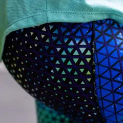Close-up of a person wearing blue leggings with a geometric triangle pattern. This image could be part of a tutorial on how to sew leggings.