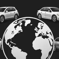 Białe samochody otaczają globus, symbolizując zasięg największych koncernów motoryzacyjnych.
