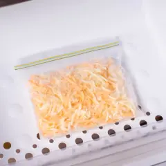 Sacchetto con formaggio grattugiato pronto per essere congelato. Si può congelare il formaggio grattugiato per averlo sempre a disposizione.
