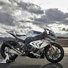 La BMW HP4 Race, una moto de competición lista para la pista, descansa bajo un cielo dramático.