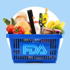 A blue shopping basket filled with groceries, including bread, cheese, and produce, with the FDA logo prominently displayed. This image represents food safety regulations overseen by the FDA and USDA.