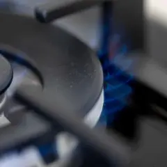 Płomień palnika gazowego, symbolizujący kontrolę instalacji gazowej w bloku.