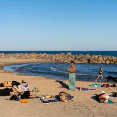 Cours de yoga sur la plage de Frontignan avec vue sur la mer et les étangs.
