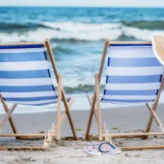 Dwa leżaki na plaży, kapelusze i torba plażowa. Idealne miejsce na algierskie wakacje.