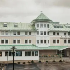 Home Hotel Fregatten i Varberg, med sitt gröna tak och ljusa fasad, välkomnar gäster.