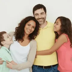 Familia feliz y sonriente, ideal para promocionar cursos para padres.