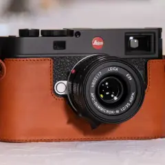 A Leica M camera in a brown leather case, with a Leica APO-Summicron-M 1:2/35 ASPH. lens. Are Leica cameras good? This one certainly looks the part.