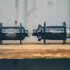 Two black Onyx Vesper hubs, one with a skull and bike graphic, the other with the Onyx logo, ready for a review.