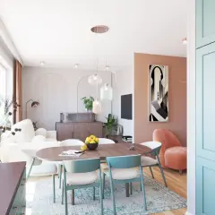 Otwarty salon z jadalnią i kuchnią. Jasne wnętrze z pastelowymi akcentami, wygodna sofa, stół z krzesłami i nowoczesna zabudowa kuchenna.