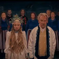 Grupa ludzi w tradycyjnych strojach, z młodą kobietą w białej sukni i wianku na czele. W tle widać innych mężczyzn i kobiety, przypominających **chłopów** z dawnych czasów.