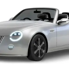 Srebrny kabriolet Daihatsu Vision Copen z okrągłymi światłami i siatkowym grillem.