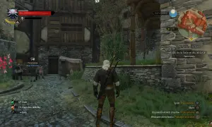 Geralt w arcymistrzowskim rynsztunku kota stoi na kamiennej ścieżce przed kamienno-drewnianym budynkiem.