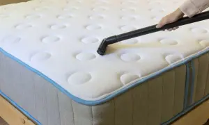 Vacuuming mattresses to remove dust mites and allergens.