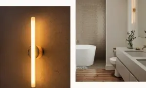 Modern wall sconces, like this sleek vertical tube light, prove they are far from out of style, adding a warm glow to a contemporary bathroom.