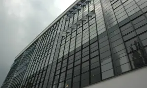 Szklana fasada budynku, przykład modernizmu. Charakterystyczne okna wychylne tworzą ciekawy wzór.