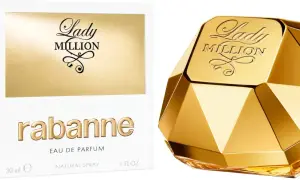 Złoty flakon perfum Lady Million od Rabanne, przypominający diament, obok białego pudełka z napisem "one milon".