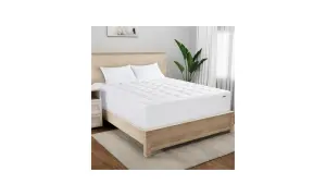 A Serta mattress topper on a bed. Wondering how long does a Serta mattress take to expand? This topper is ready for sleep.