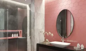 Bagno moderno con doccia, dove le piastrelle rosa a nido d'ape contrastano con il grigio e il marmo.