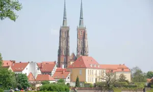 Zwei Türme des Domsinsel Breslau ragen über rote Dächer. Ein sonniger Tag über der Stadt.