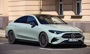 Jasnoszary Mercedes CLA 180 z czarnym dachem stoi na ulicy przed kamienicą.