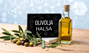 En flaska gyllene olivolja, färska oliver och en skylt med texten "OLIVOLJA HALSA". Olivolja nyttigt för hälsan.