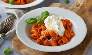 Nduja pasta med krämig burrata, toppad med basilika och olivolja. En härlig italiensk rätt.