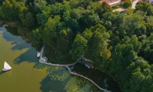 Drewniane pomosty i łódki tworzą fajne miejsca nad jeziorem, otoczone bujną zielenią.