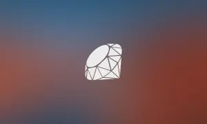 Biały symbol szlifowanego kamienia szlachetnego, przypominający logo języka programowania ruby, na tle gradientu od niebieskiego do czerwonego.