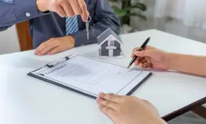 Firma del contratto di compravendita immobiliare con consegna delle chiavi. La procura generale notarile è un atto fondamentale.
