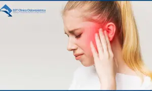 Ragazza con dolore mandibola stress, si tocca il viso arrossato.