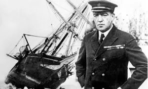 Ernest Shackleton, en modig polarforskare, står framför sitt skepp som fastnat i isen.
