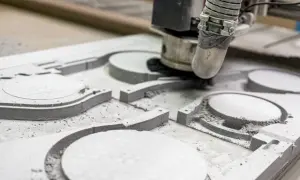 Precyzyjne frezowanie CNC tworzy skomplikowane kształty w materiale. Maszyna usuwa warstwy, tworząc detale.