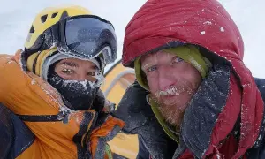 Tomasz Mackiewicz und ein Bergsteigerkollege, bedeckt mit Schnee, blicken in die Kamera.