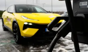 Gul elbil laddas vid en snabbladdare elbil.