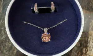 Eleganckie **Swarovski komplety**: naszyjnik z brzoskwiniowym kryształem i kolczyki w pudełku.