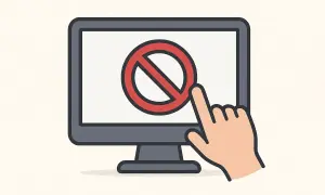 Palec wskazujący dotyka czerwonego symbolu zakazu na ekranie komputera, ilustrując, jak zablokować stronę internetową.