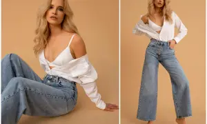 Blondynka w szerokich jeansach i białej koszuli. Stylizacja, która będzie modna w 2023 roku, to luźne fasony i klasyczne połączenia.