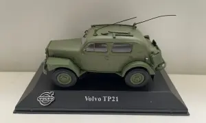 Modell av en grön Volvo TP21 "Sugga" med antenner och takräcke, monterad på en svart piedestal.