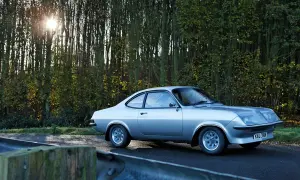 Silver Vauxhall Firenza på en väg kantad av träd. Solen skiner genom grenarna.