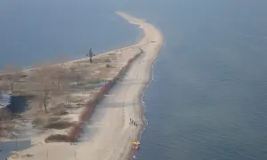 Półwysep w Rewie z krzyżem i plażą. Atrakcje turystyczne tego miejsca przyciągają spacerowiczów.