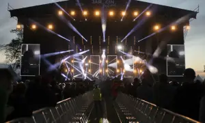 Jarocin Festival rozświetlony tysiącami świateł. Tłum czeka na koncert, a na scenie widać artystów.