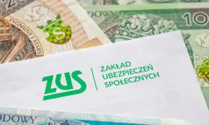 Koperta ZUS na tle polskich banknotów. Dokumenty dotyczące zasiłku chorobowego i pieniędzy.