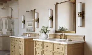 Elegant bathroom with double vanity, brass fixtures, and modern vanity light height 8 ft ceiling.