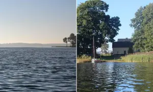 Spokojne jezioro Urszulewskie z łódką przy pomoście i domkiem w tle.