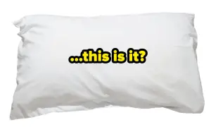 A white pillow with the text "...this is it?" in yellow and black. It makes you wonder, how many pillows do you sleep with?