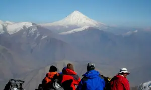 Vier Wanderer blicken auf das majestätische Demavend-Gebirge im Iran.