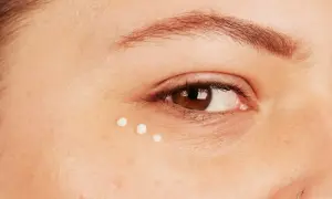 Trois petites gouttes de crème illuminent le coin de l'œil, prenant soin des yeux sensibles.