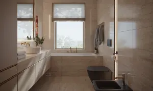 Nowoczesna łazienka z oknem na wprost drzwi, wanna, czarna miska WC i bidet, kamienne płytki, złote baterie.