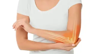 Ból łokcia, widoczny na tle kości i mięsaków, sugeruje problem z tkanką.